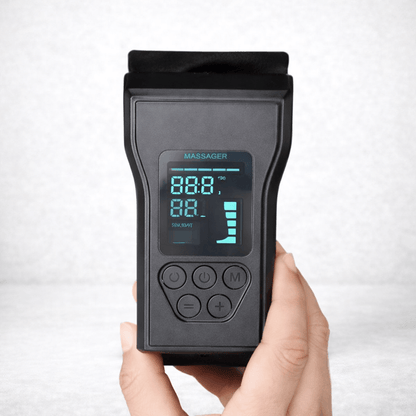 Close-up of a hand holding the control panel for VascuForce™ wireless recovery boots with digital display.